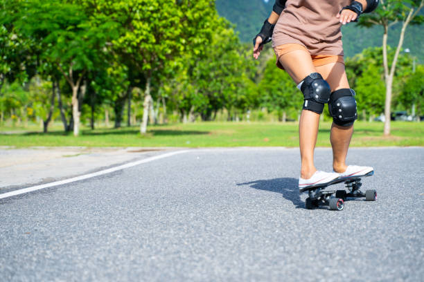 istock girl play surfskate in park 1323973819