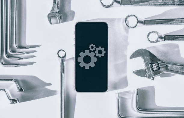 istock Smartphone service. Technician workplace with phone and special repairing tools. Electronic smart phone technology service. 1323975646