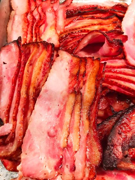istock traditional English fried bacon strips for breakfast. 1323975688
