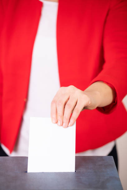 istock Voter Putting Ballot Into Voting box. 1323975803
