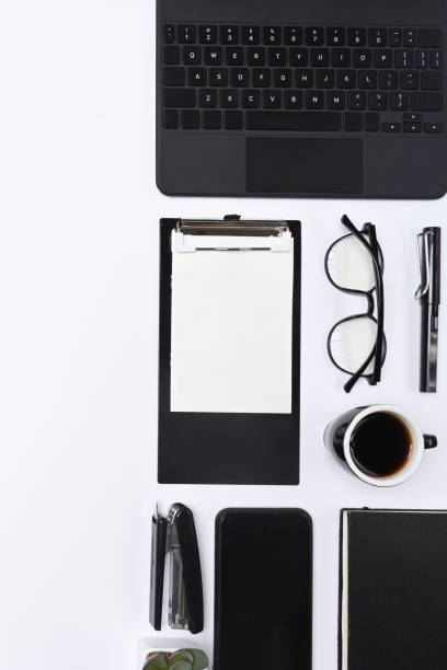 istock Mobile phone, clipboard, glasses, coffee cup and keyboard on white background. 1323975859