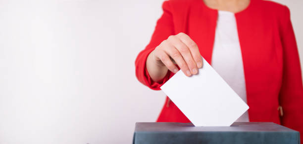 istock Voter Putting Ballot Into Voting box. 1323975949