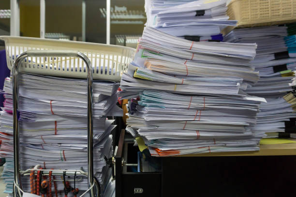 istock Busy, messy and cluttered workplace, full of documents 1323977755