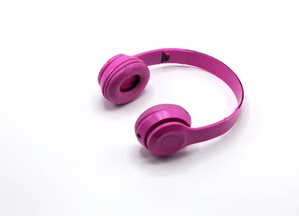 istock Wireless pink headphones isolated on white background. 1323977858