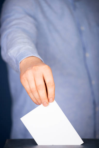 istock Voter Putting Ballot Into Voting box. 1323979640