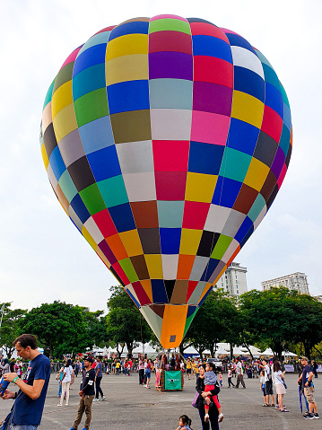 Putrajaya, Malaysia - March 28, 2019 People in the Hot Balloon Outdoor Skyride Festival watching hot balloons flying at outdoor park