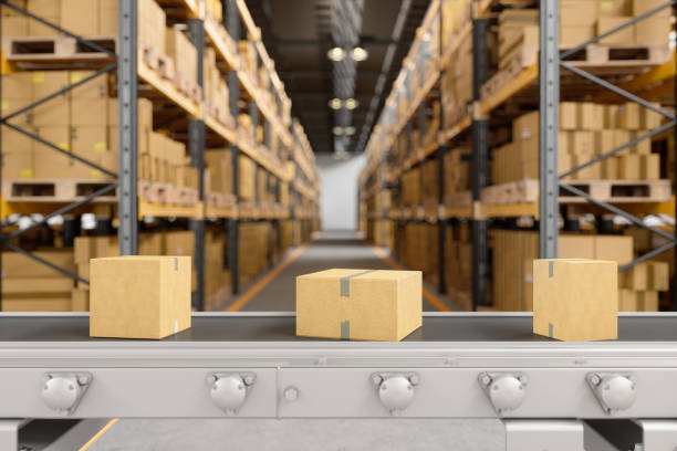 istock Cardboard Boxes Moving On Conveyor Belt In The Warehouse With Blurred Background. 1323985289