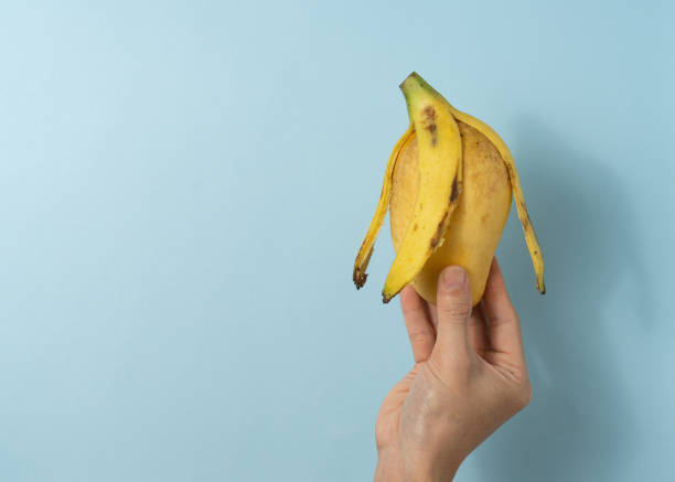 istock Hand a man hold a mango and banana peel. 1323986302