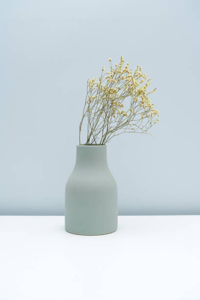 istock Put the vase with dried flowers on the white table 1323987263