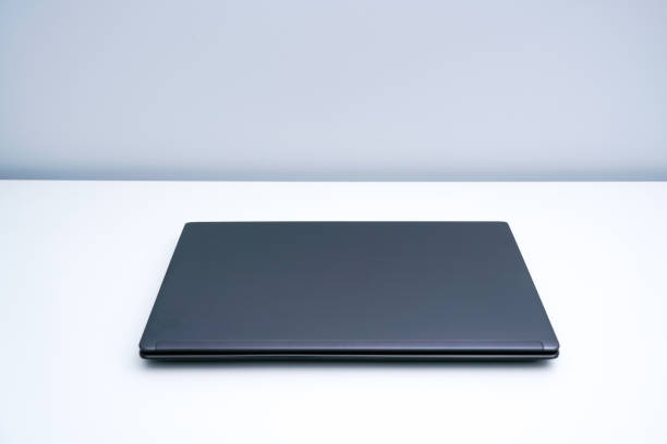 istock A dark gray laptop on a white desk 1323987352