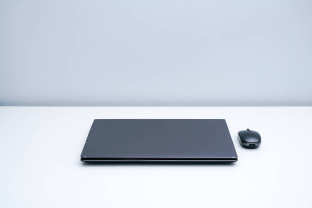 istock A dark gray laptop on a white desk 1323987421