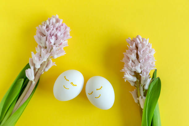 istock Hyacinth flowers with two eggs on bright yellow background with copy space for text . Happy Easter. 1323988269