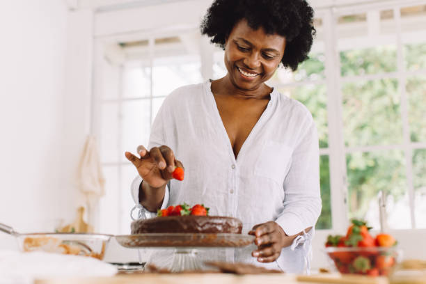 istock African female preparing delicious cake at home 1323988486