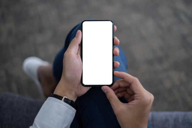istock A Man hand holding smartphone device with blank screen. top view. 1323989545