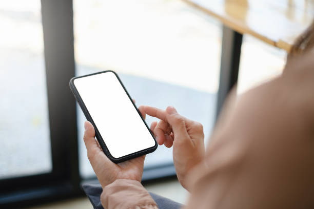 istock A woman hand holding smartphone device with blank screen. 1323989691
