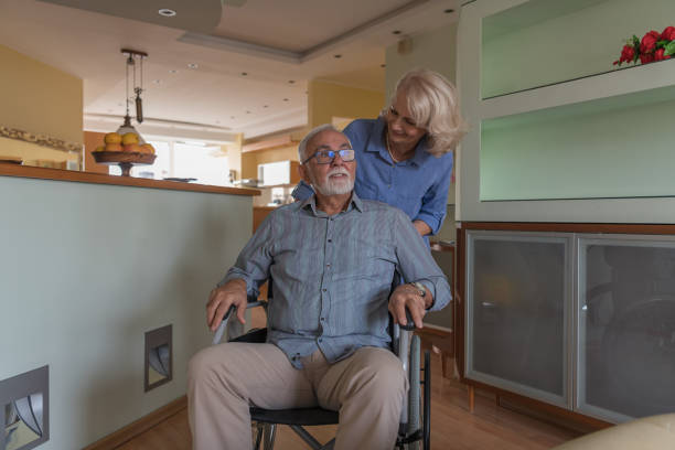 istock Woman Shows a Love to her Disabled Man. 1323990525
