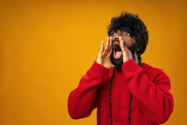 istock Screaming african american guy against yellow background 1323991008