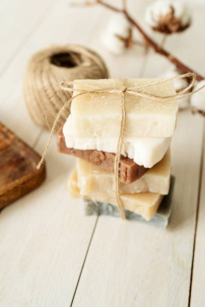 istock Stack of hand made soap on white wooden background 1323992111