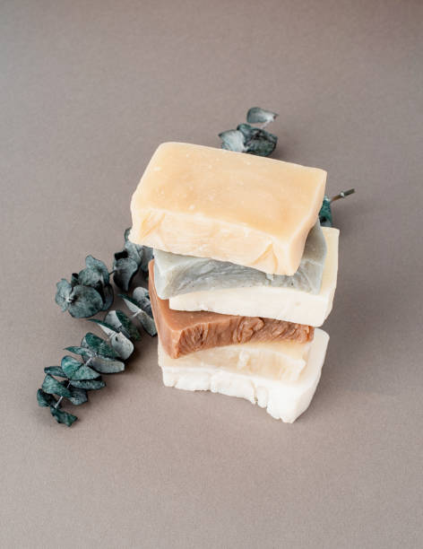 istock Stack of hand made soap and eucalyptus on gray background 1323992300