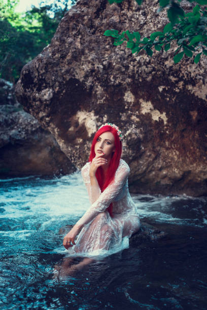 istock Beautiful young girl resting in water 1323993404