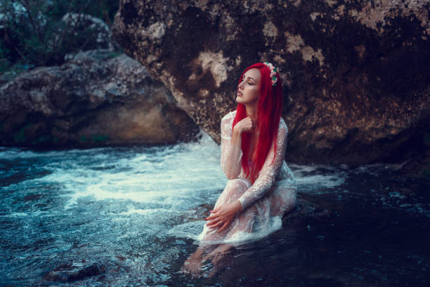 istock Beautiful young girl resting in water 1323993406