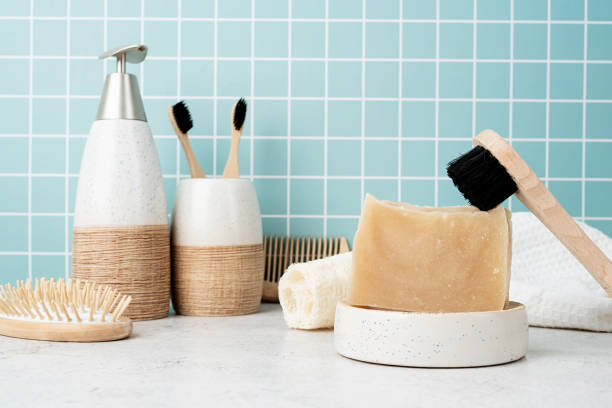 istock Bath accessories with bamboo brushes, handmade soap, dispenser and natural brushes on bath shelf 1323993417