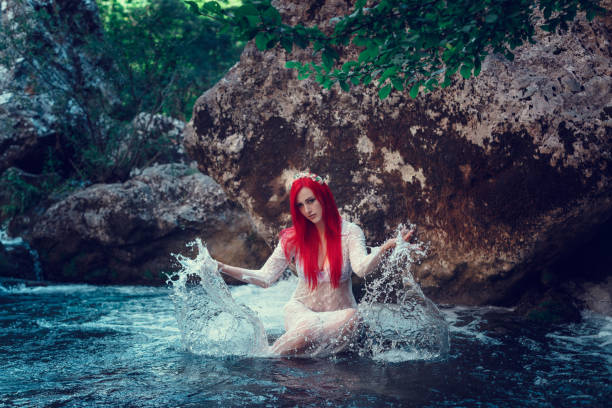 istock Beautiful young girl resting in water 1323993551