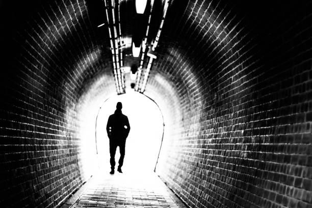 Man goes through a tunnel into the light.