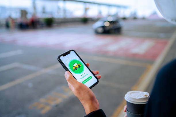 istock A man wearing a face mask and checking uber / taxi 1323994546