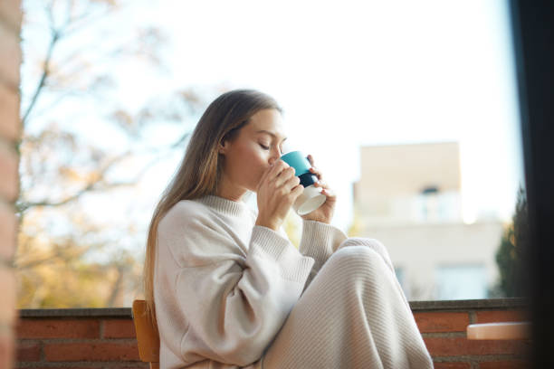 istock A beautiful woman drinking coffee and relaxing on the terrace. 1323997549