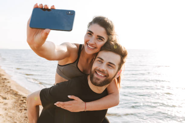 istock Cheerful young man carrying his girlfriend on his back 1323998561