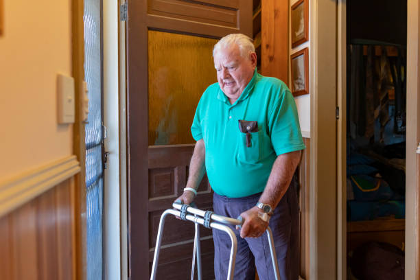 istock Senior Man Answering the Door at Home 1323998655