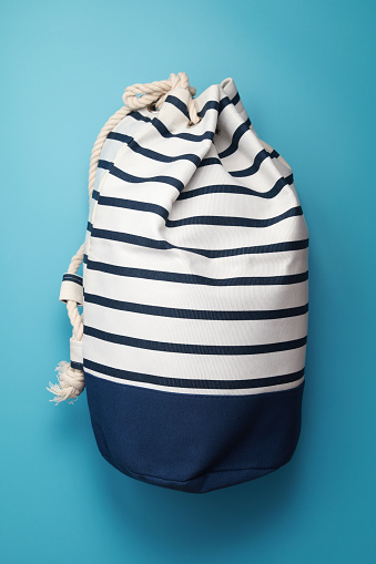 Top view, Cotton duffel bag on a blue background