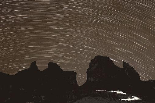 Climbers light pattern to the summit of Mt Kinabalu beneath the stars at Sabah, Malaysia