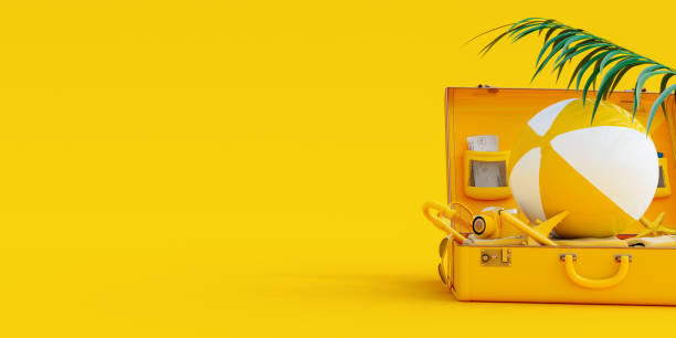 istock Suitcase with summer accessories on yellow background 1324000868