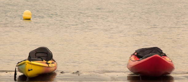 istock canoes on the beach at sunset, space for text 1324003172