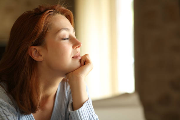 Relaxed woman resting with closed eyes at home
