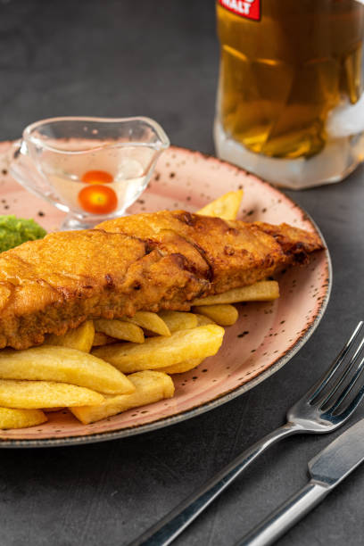 istock British Traditional Fish and chips with mashed peas, pea sauce and cold beer. 1324004424
