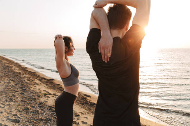 istock Healthy young couple stretching hands 1324004915