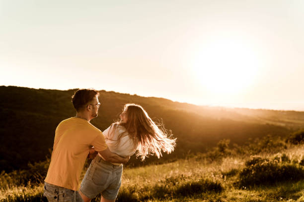 istock Happy couple in love having fun during springtime at sunset. 1324005624