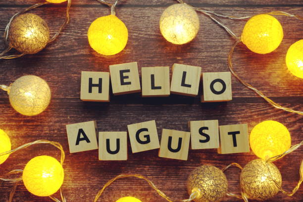 istock Hello August alphabet letter with LED cotton balls on wooden background 1324006242