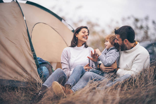istock Happy family talking during camping day in autumn. 1324006812