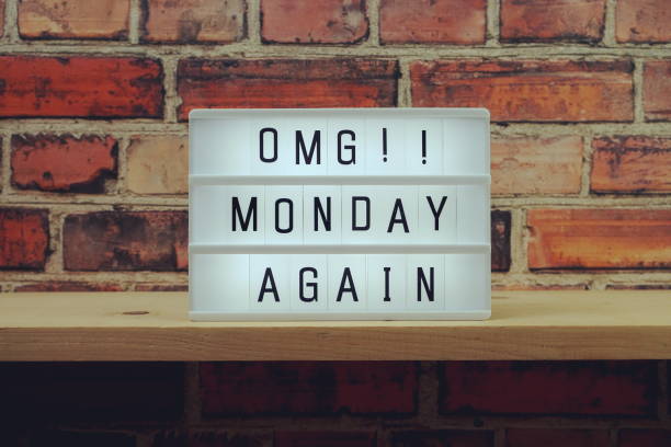 istock Monday Again word in light box on brick wall and wooden shelves background 1324006873