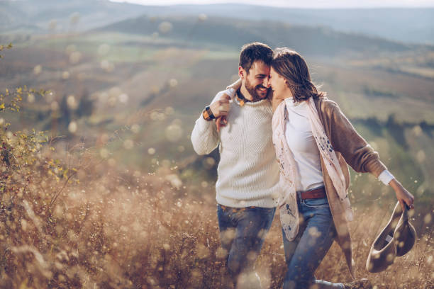 istock Happy couple walking embraced in nature. 1324007557