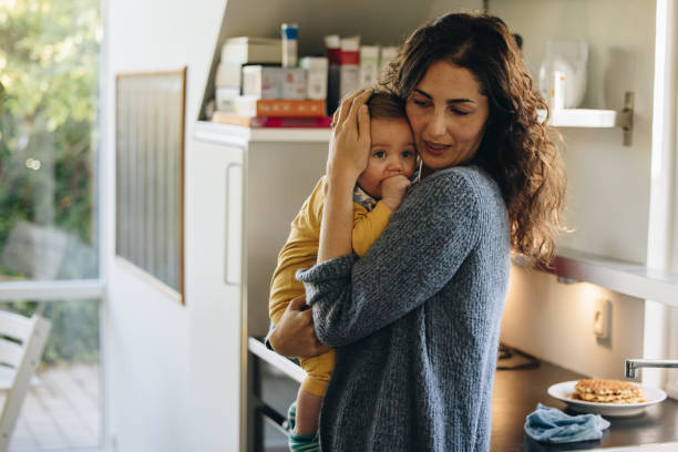 istock Mother consoling her baby 1324007839