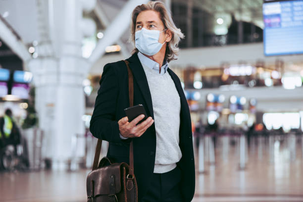 istock Transit passenger with face mask at airport 1324008316