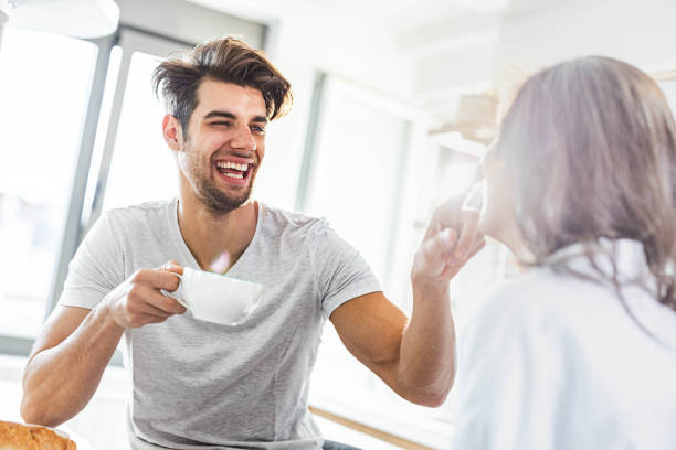 istock Happy affectionate man touching his girlfriend's nose during coffee time in the morning. 1324008874