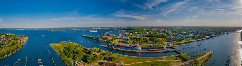 Panorama aerial view of the Kiel Canal waterway with lockage Holtenau. Cargo ships pass the Holtenau lock of the Kiel Canal. Industrial area at the Kiel Canal.