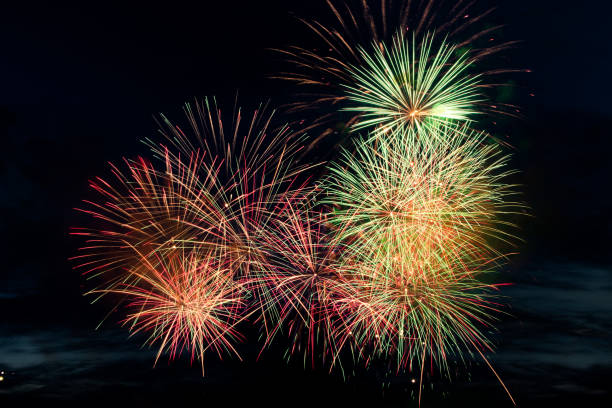 istock Colorful fireworks on black background. Celebration and holidays concept. Independence Day 4th of July, New Year, festival. Bright explosions of lights in sky. 1324009109