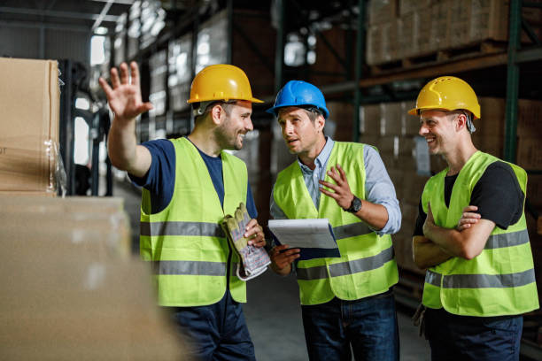 istock Manager giving instructions to his workers in distribution warehouse. 1324010090